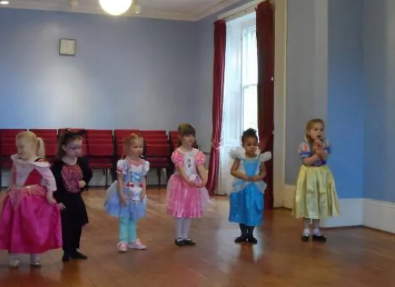 Pre-school dancers in party dresses during a class in Harlow
